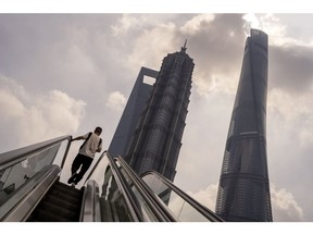 Pedestrians ride escalators in Pudong's Lujiazui Financial District in Shanghai, China, on Monday, Sept. 18, 2023. China's economy picked up steam in August as a summer travel boom and a heftier stimulus push boosted consumer spending and factory output, adding to nascent signs of stabilization. Photographer: Raul Ariano/Bloomberg