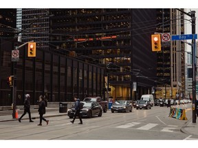 Pedestrians in the financial district of Toronto, Ontario, Canada, on Wednesday, Nov. 8, 2023. The S&P/TSX Composite rose 0.3%, with six of 11 sectors higher, led by energy stocks.