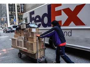 A driver for an independent contractor to FedEx delivers packages on Cyber Monday in New York, US, on Monday, Nov. 27, 2023. An estimated 182 million people are planning to shop from Thanksgiving Day through Cyber Monday, the most since 2017, according to the National Retail Federation.