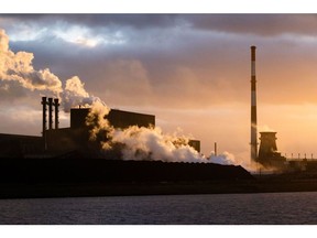 Vapour rises from chimneys at the Arcelormittal SA coking plant at the Port of Dunkirk in Dunkirk, France, on Monday, Dec. 11, 2023. France's economy will avoid a recession thanks to the services sector, according to a central bank survey.