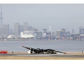 The wreckage of Japan Airlines Flight 516 at Haneda Airport in Tokyo on Jan. 3. Photographer: Kentaro Takahashi/Bloomberg