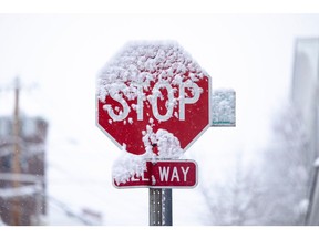 A snow covered stop sign during a storm in Hudson, New York, US, on Sunday, Jan. 7, 2024. Hundreds of flights have been grounded across the US from a pair of winter storms that left more than a foot of snow in New York's Hudson Valley and sparked blizzard warnings across the Great Plains.