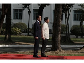 Joko Widodo, Indonesia's president, left, with Ferdinand Marcos Jr., Philippines president, inspect an honor guard at the Malacanan Palace grounds in Manila, the Philippines, on Wednesday, Jan. 10, 2024. Indonesia President Joko Widodo said the situation in the South China Sea as well as trade will be among his discussion points with Philippine President Ferdinand Marcos Jr. during his visit to Manila.