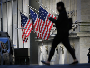 Pedestrian walks in front of New York Stock Exchange
