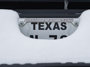  A licence plate covered in snow on a truck in McKinney, Texas, Feb. 16, 2021. 