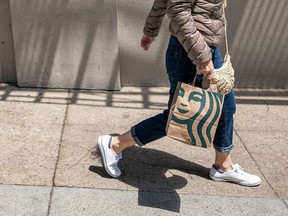 A pedestrian carries a Starbucks bag in San Francisco.