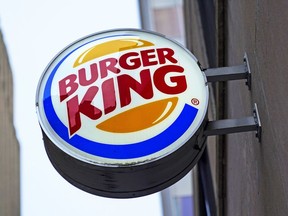 The Burger King logo is displayed on a sign outside a restaurant in downtown Pittsburgh on Wednesday, Jan. 12, 2022. Restaurant Brands International Inc. says it has signed a deal to buy Carrols Restaurant Group, the largest Burger King franchisee in the United States, in a deal worth US$1 billion.THE CANADIAN PRESS/AP/Gene J. Puskar