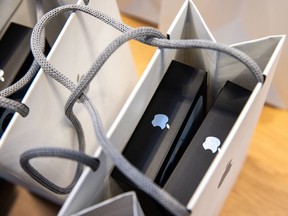 Apple smartphones inside a shopping bag at an Apple store in New York. Growing concerns over iPhone sales have triggered two Apple downgrades so far this week.