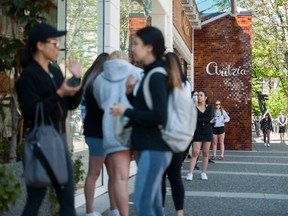 Customers line up to enter an Aritzia store in Vancouver in May 2020.