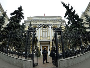 A police officer guards the entrance to the head office of the Central Bank in Moscow.