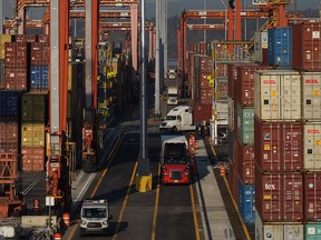 Cargo containers are moved by trucks at a Port of Vancouver terminal. GHe growth came from goods-producing industries, including manufacturing and wholesale trade, which saw their biggest gains since January 2023.