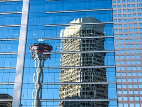 The reflected Calgary Tower and downtown Calgary office buildings. While office vacancy remains high in older buildings, higher class buildings have seen their vacancy rates fall below 20 per cent.