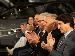 Prime Minister Justin Trudeau and Ontario Premier Doug Ford applaud during an announcement on a Volkswagen electric vehicle battery plant in St. Thomas, Ont., last April.
