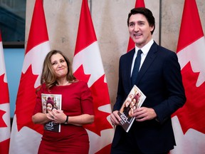 Finance Minister Chrystia Freeland and Prime Minister Justin Trudeau pose with copies of the Fall Economic Statement on Nov. 21, 2023. The Business Council of Canada is warning that Ottawa will miss fiscal targets put in place to control a budget shortfall.