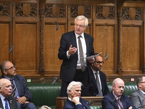 In this photo issued by UK Parliament, Member of Parliament David Davis asks a question to Secretary of State for Business and Trade Kevin Hollinrake, during an urgent question on the Post Office Horizon scandal in the House of Commons, London, Wednesday Jan. 10, 2024.
