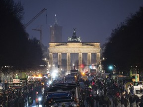 Tractors are parked in preparation for the German Farmers' Association demonstration at the Brandenburg Gate, Berlin, Sunday Jan. 14, 2024, in protest about a plan to cut their fuel subsidies.