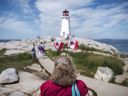 Tourists visiting the lighthouse in Peggy's Cove, N.S.
