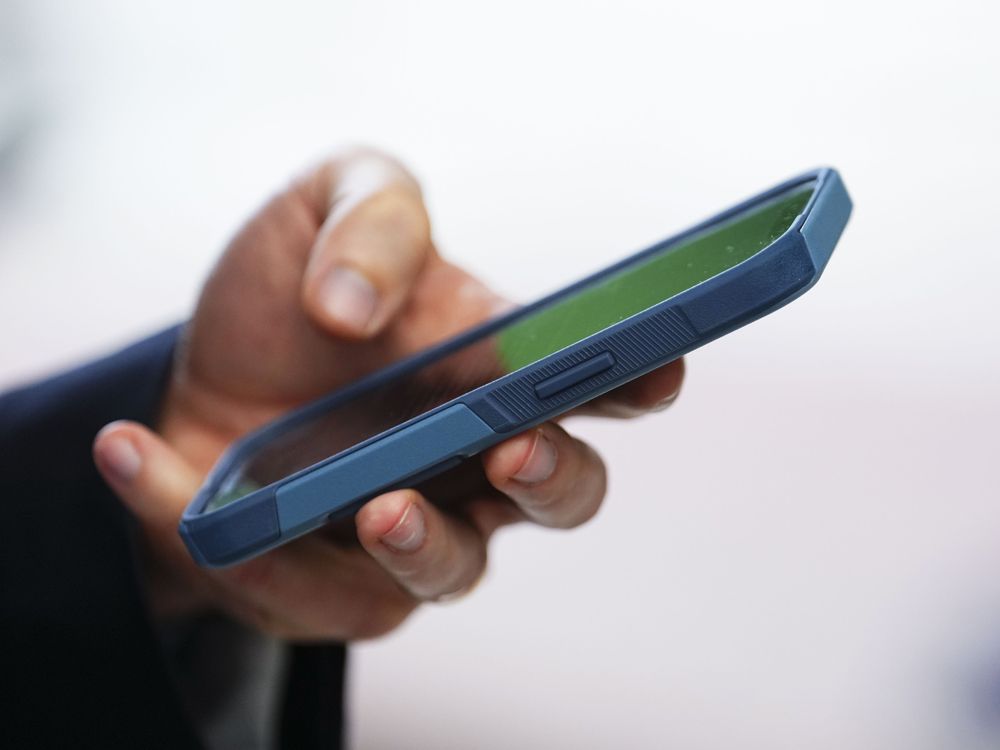 A person uses a cellphone in Ottawa.