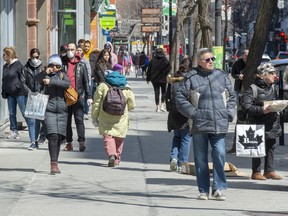 Pedestrians walk down St. Catherine Street in Montreal.