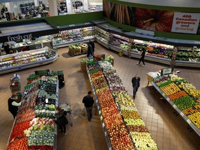 Shoppers browse produce at a Loblaw Cos. Ltd. grocery store in Toronto.