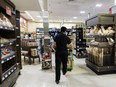 A worker walks around a Metro Inc. grocery store in Toronto.