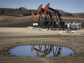 Pumpjacks draw out oil and gas from wellheads near Calgary.