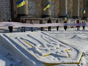 Activists hold a 50-meter-long rushnyk, a decorative and ritual cloth, as a sign of unity of residents of all Ukrainian regions to mark the Day of Unity of Ukraine, in Kharkiv on Jan. 22, amid the Russian invasion of Ukraine.