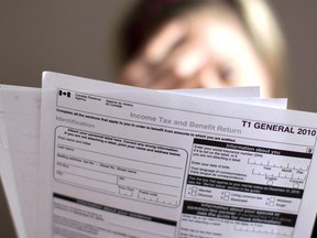 A woman looks at a tax return form in Toronto.