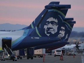 FILE - Alaska Airlines planes are shown parked at gates at sunrise, March 1, 2021, at Seattle-Tacoma International Airport in Seattle. An Alaska Airlines flight made an emergency landing in Oregon on Friday, Jan. 5, 2024, after a window and chunk of its fuselage blew out in mid-air, media reports said.