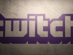 FILE - The logo for live-streaming video platform Twitch is seen on Nov. 4, 2017, at the Paris games week in Paris, France. Twitch is laying off more than 500 employees, Wednesday, Jan. 10, 2024, as the company looks to get to a more appropriate size, according to the streaming platform's CEO Dan Clancy.