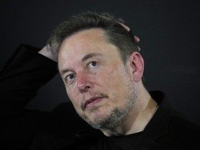 FILE - Elon Musk appears at an event with Britain's Prime Minister Rishi Sunak in London, on Nov. 2, 2023. According to Musk, the first human received an implant from his computer-brain interface company Neuralink over the weekend.