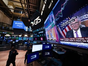 File - Federal Reserve chairman Jerome Powell appears on a video monitor on the floor at the New York Stock Exchange in New York on July 26, 2023. Most analysts expect the central bank will leave its benchmark rate alone when the Federal Reserve wraps up a two-day rate policy meeting on Wednesday, Jan. 31, 2024.