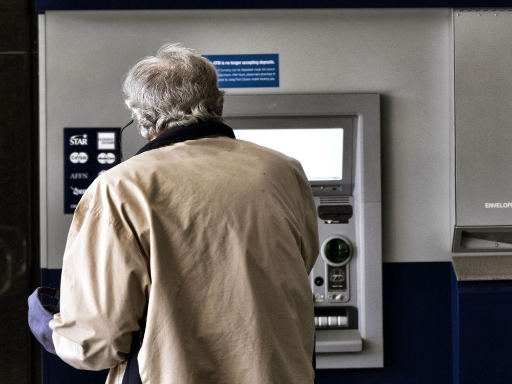 File - A customer makes a transaction at an automatic teller machine in Los Angeles on March 27, 2023. The cost to overdraw a bank account could drop to as little as $3 under a proposal announced by the White House, the latest move by the Biden administration to combat fees it says pose an unnecessary burden on American consumers, particularly those living paycheck to paycheck.