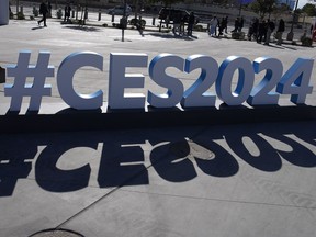 FILE - People walk by a CES sign during the CES tech show, Jan. 10, 2024, in Las Vegas. The best CES products pierce through the haze of marketing hype at the Las Vegas gadget show to reveal innovations that could improve lives. The worst could harm us or our society and planet in such "innovatively bad" ways that a panel of self-described dystopia experts has judged them "Worst in Show." The third annual contest that no tech company wants to win announced its decisions Thursday, Jan. 11, and faults a number of well-known brands including BMW, Amazon, Instacart and Sennheiser.