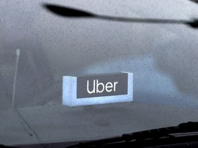 FILE - An Uber sign is displayed inside a car, May 15, 2020, in Chicago. The Biden administration will enact a new labor rule Tuesday, Jan. 9, 2024, that aims to prevent the misclassification of workers as "independent contractors," a step that could bolster both legal protections and compensation for many in the U.S. workforce.