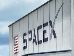 FILE - The SpaceX logo is displayed on a building, May 26, 2020, at the Kennedy Space Center in Cape Canaveral, Fla. On Wednesday, Jan. 3, 2024, a U.S. labor agency accused SpaceX of unlawfully firing employees who penned an open letter critical of CEO Elon Musk and creating an impression that worker activities were under surveillance by the rocket ship company.