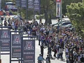 FILE - People line up to get into a memorial service at McKale Memorial Center on the University of Arizona campus, Jan. 12, 2011, in Tucson, Ariz. On Wednesday, Dec. 13, 2023, the University of Arizona unveiled an extensive financial recovery plan to address its $240 million budget shortfall.