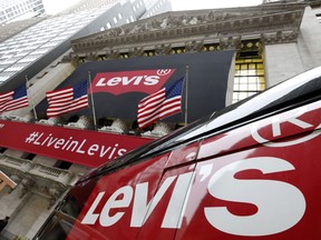 FILE - A Levi's banner adorns the facade of the New York Stock Exchange, March 21, 2019. Denim giant Levi Strauss & Co. said Thursday, Jan. 25, 2024, that it's slashing its global corporate workforce by 10% to 15% in the first half of the year as part of a two-year restructuring plan that seeks to simplify its operations.