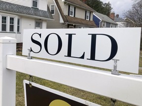 FILE - A sold sign hangs in front of a Brighton, New York house on Tuesday, February 21, 2023. The average rate on a 30-year mortgage rose to 6.66% from 6.62% last week, mortgage buyer Freddie Mac said Thursday, Jan. 11, 2024.