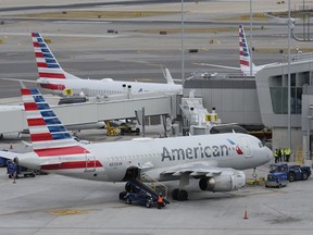 FILE - American Airlines planes sit on the tarmac at Terminal B at LaGuardia Airport, Jan. 11, 2023, in New York. A man who was arrested earlier in the week in Amarillo, Texas, for assaulting and American Airlines flight attendant and arresting police officers is facing a charge of interfering with a flight crew, punishable by up to 20 years in prison if convicted, according to an FBI agent's account unsealed Friday, Jan. 5, 2024.