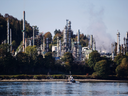 A boat travels past the Parkland Burnaby Refinery on Burrard Inlet in British Columbia.