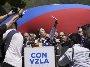 Opposition coalition presidential hopeful Maria Corina Machado gives a press conference outside her campaign headquarters in Caracas, Venezuela, Monday, Jan. 29, 2024, days after the country's highest court upheld a ban on her presidential candidacy.