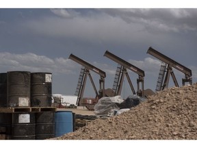 Pumpjacks near a Diamondback Energy oil rig in Midland, Texas, in 2019.