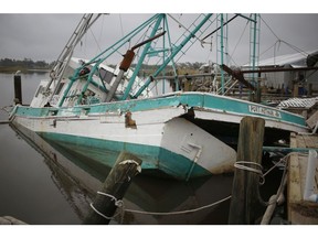 A shrimp boat sits damaged at a dock after Hurricane Delta made landfall in Hackberry, Louisiana, U.S., on Sunday, Oct. 11, 2020. Delta weakened to a tropical depression as it moved inland over northeastern Louisiana, knocking out power lines and drenching an area still recovering from the onslaught of Hurricane Laura.