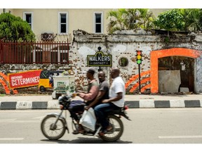 A moto taxi carries two passengers in Lagos, Nigeria, on Friday, April 22, 2022. Choked supply chains, partly due to Russia's invasion of Ukraine, and an almost 100% increase in gasoline prices this year, are placing upward price pressures on Africa's largest economy. Photographer: Damilola Onafuwa/Bloomberg
