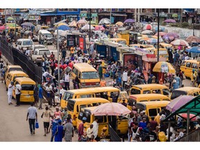 Market stall vendors and commuters in Lagos.