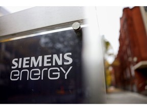 A Siemens Energy AG logo on a sign at the company's gas turbine factory in Berlin, Germany, on Friday, Oct. 27, 2023. Siemens Energy AG is in talks with the German government about securing as much as 16 billion ($16.9 billion) in state guarantees as problems at its wind-turbine unit spread to the rest of the business. Photographer: Liesa Johannssen-Koppitz/Bloomberg