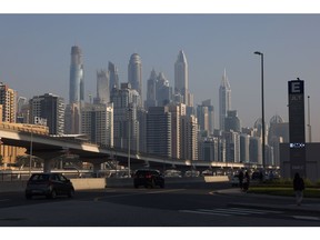 Skyscraper office buildings beyond a road and railway line in Dubai, United Arab Emirates, on Wednesday, Nov. 29, 2023. More than 70,000 politicians, diplomats, campaigners, financiers and business leaders will fly to Dubai to talk about arresting the world's slide toward environmental catastrophe.