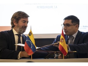 Repsol SA executive managing director Francisco Gea, left, and Venezuela's oil minister Pedro Rafael Tellechea during a news conference in Caracas on Dec. 18.