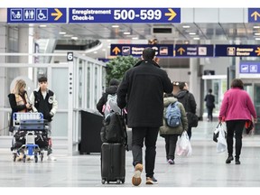 Travelers at Montreal-Pierre Elliott Trudeau International Airport (YUL) in Montreal, Quebec, Canada, on Wednesday, Dec. 20, 2023. The airport will welcome its 21 millionth passenger in the coming weeks, after a record year for traffic.